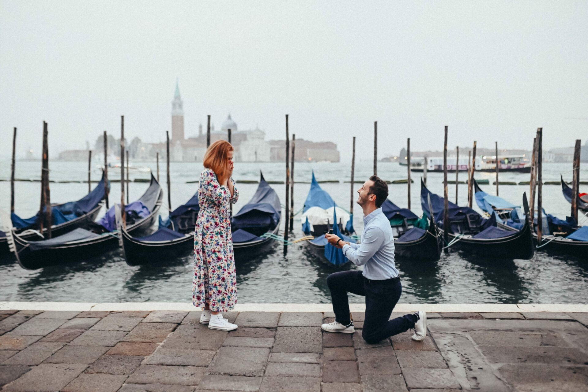 Man proposing to a woman with the Venetian laguna in the background